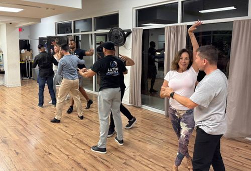 Latin Hustle dancers perform with energy